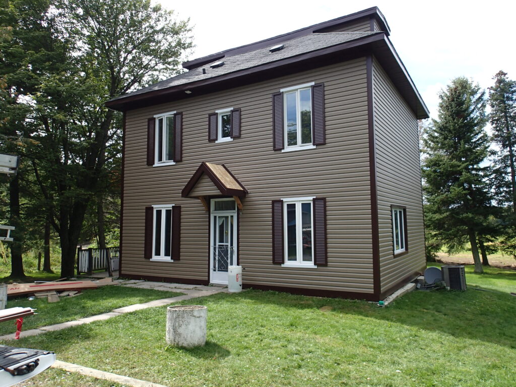 Two story Ottawa siding project with brown vinyl siding and white trim
