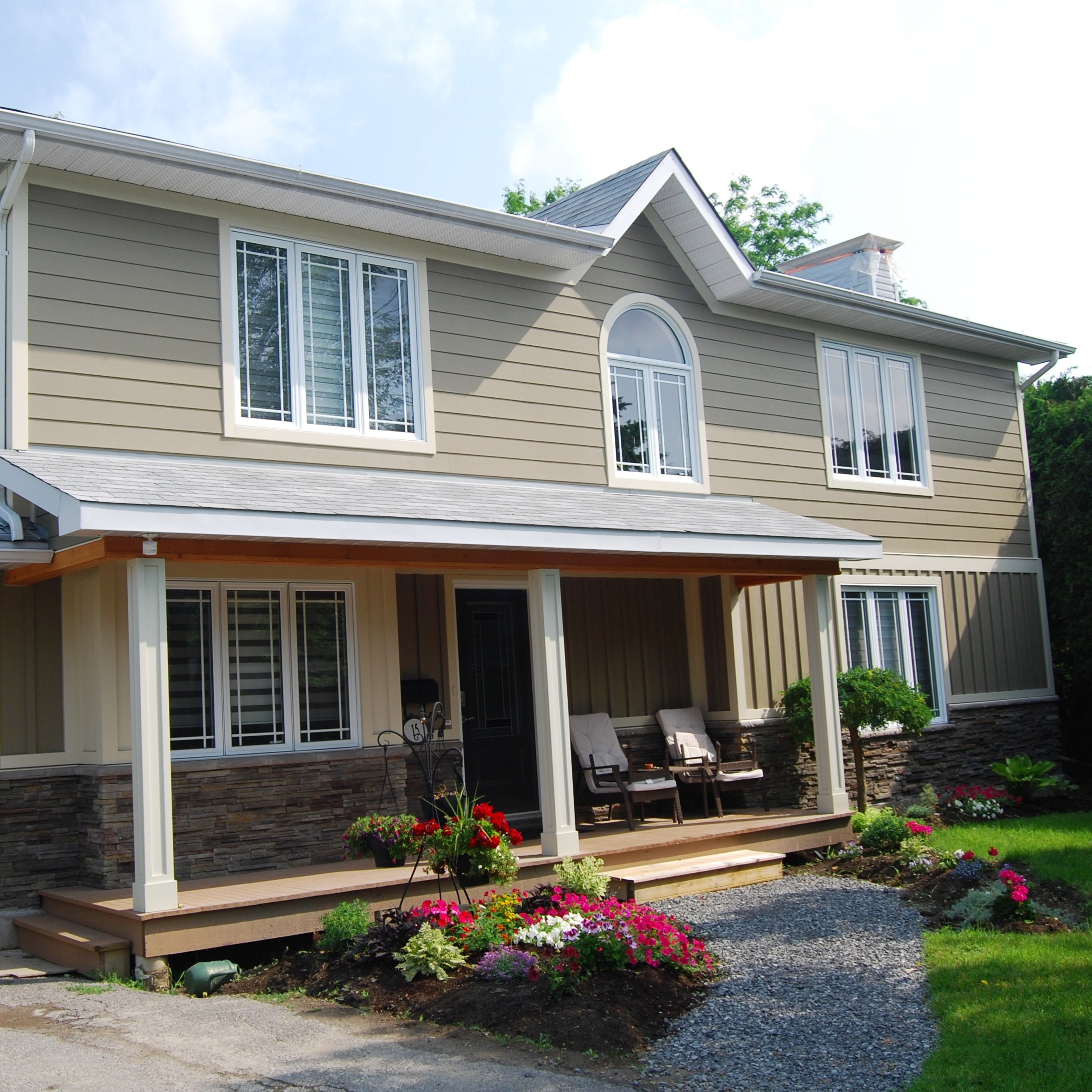 Two story siding project in Ottawa with beige siding and white accents