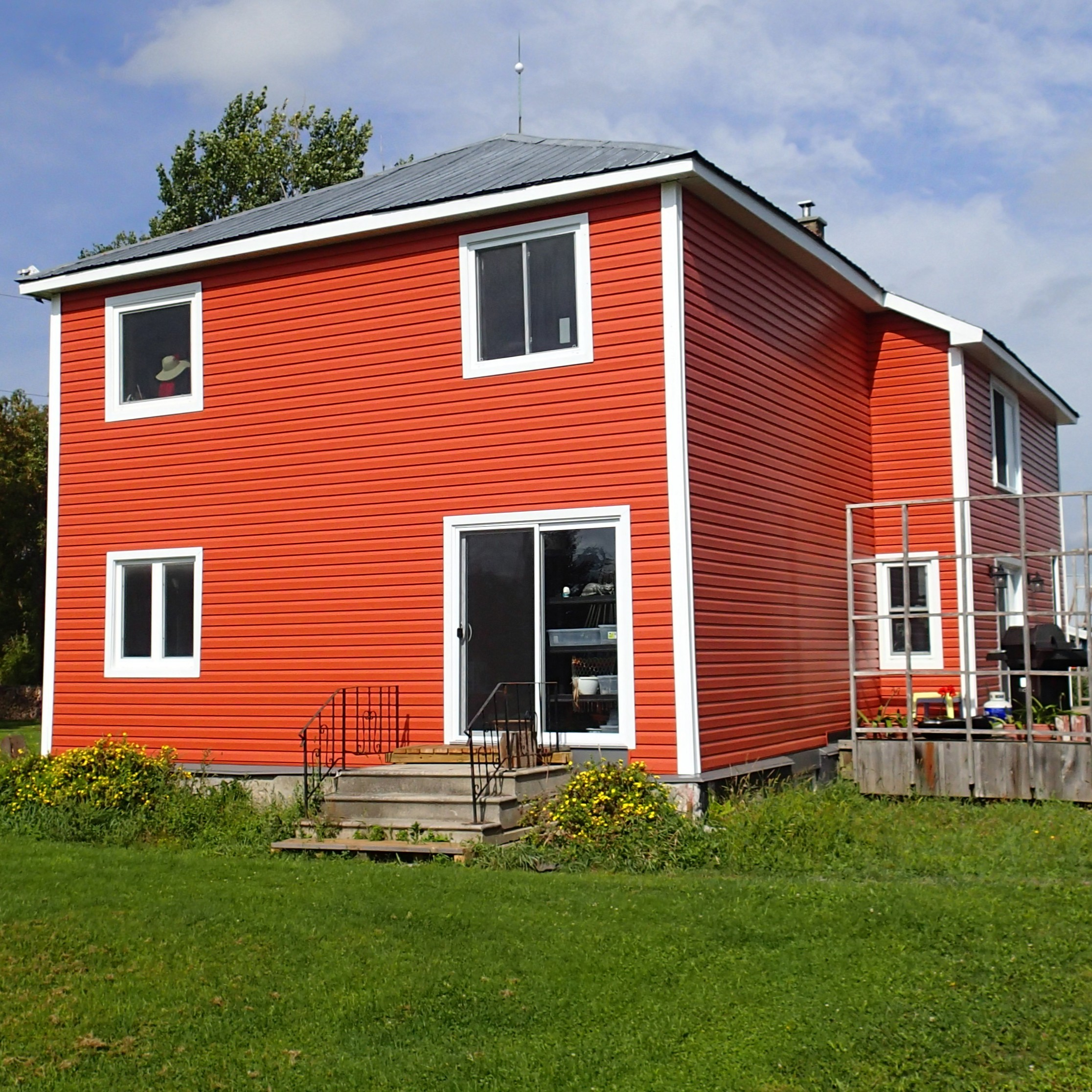 Burnt orange Ottawa siding project with white trim and vinyl siding